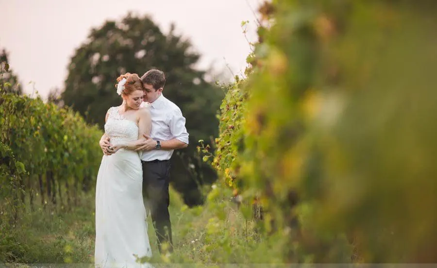 Australian citizens Bride and groom embracing in a vineyard in Tuscany
