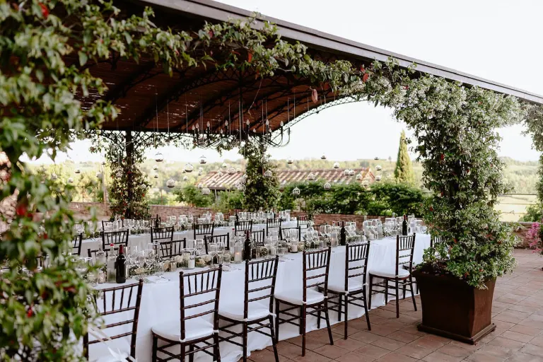 Wedding table with a view under the vine pergola in Chianti