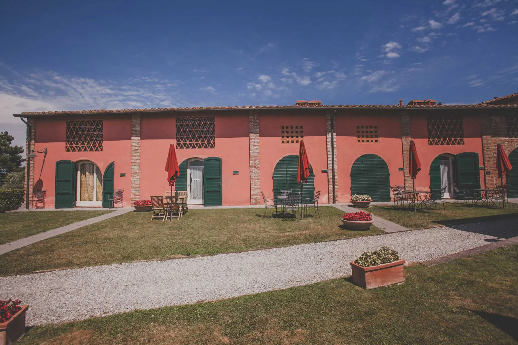 Hamlet near Pisa with red-brick buildings and lawn