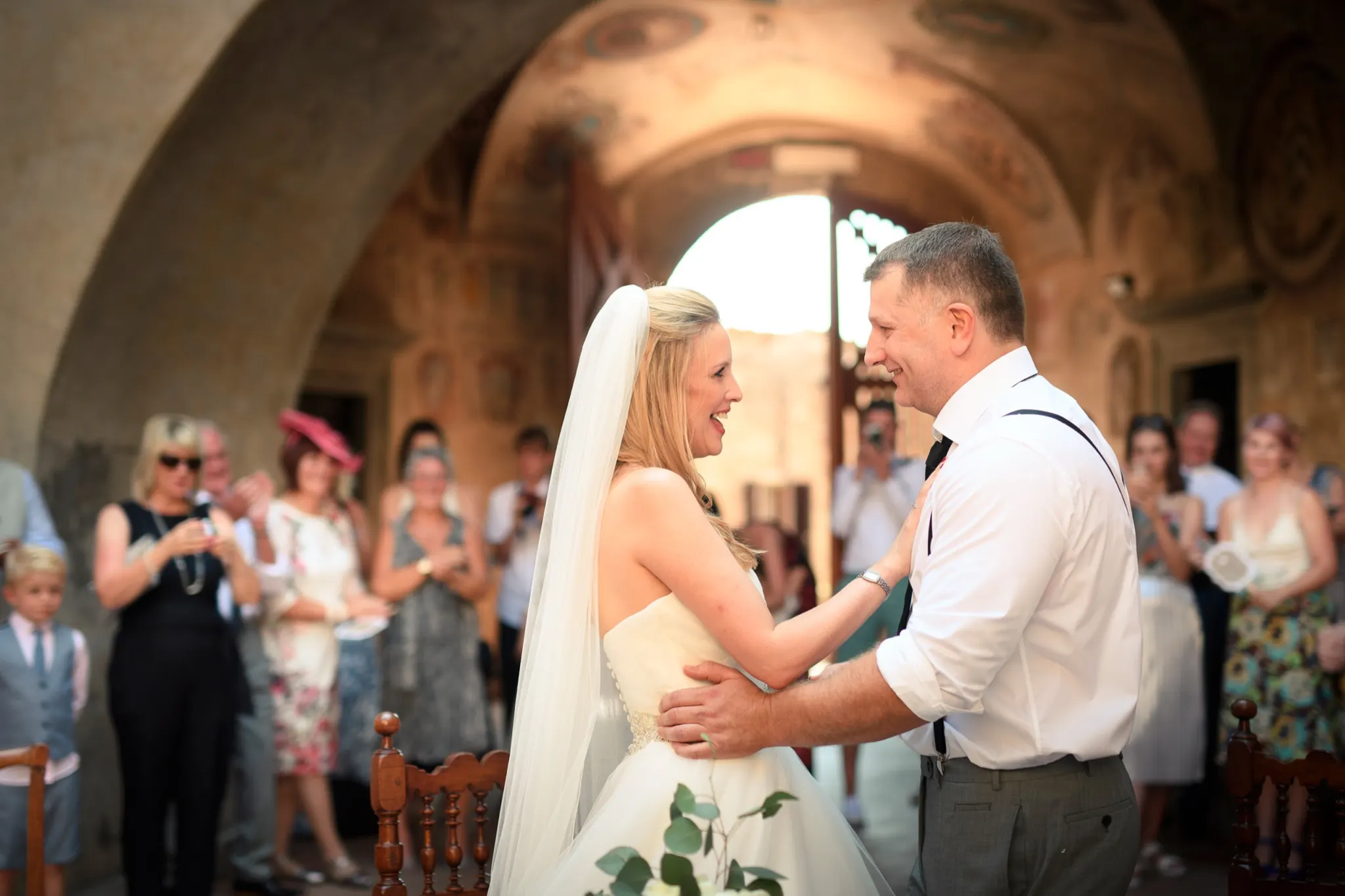 Efffetti® Wedding Planners In Tuscany - Italy Bride and groom embracing during their civil wedding in the town hall of Certaldo