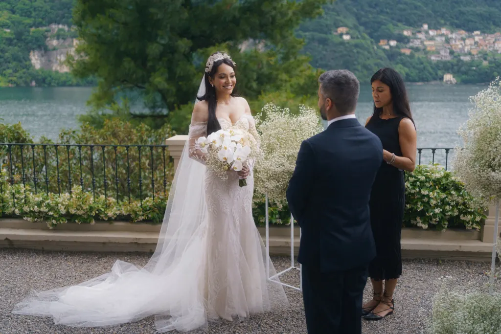 Beyond Tuscany Bride and groom during their wedding ceremony on a terrace above Lake Como