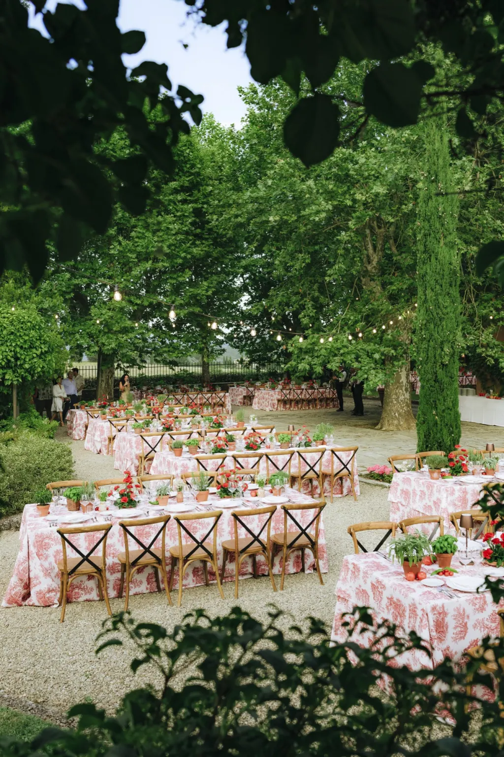 Guests from Welcome lunch tables with red toile tablecloths at Villa La Selva