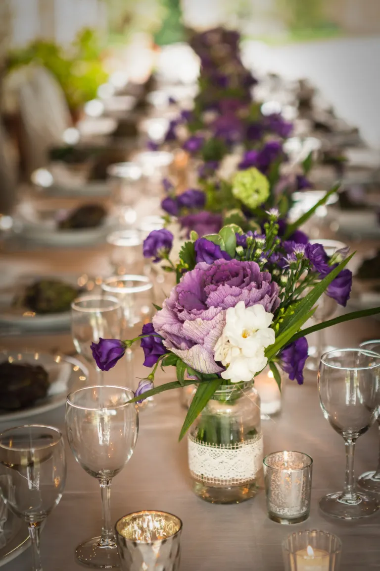 Wedding centrepiece of purple and white flowers
