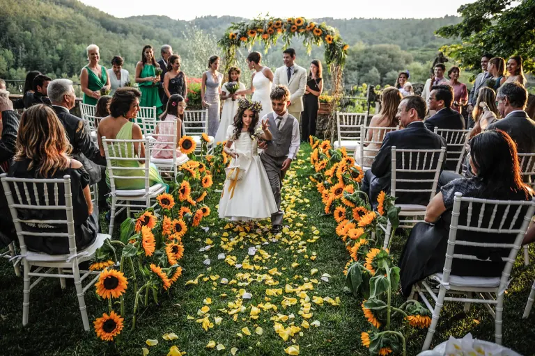 Wedding ceremony aisle lined with sunflowers in Tuscany