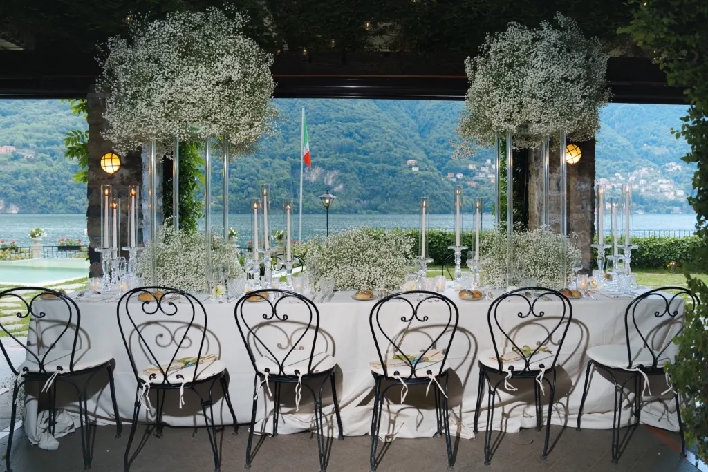 The Italian lakes Wedding dinner table with baby's breath and candles overlooking Lake Como