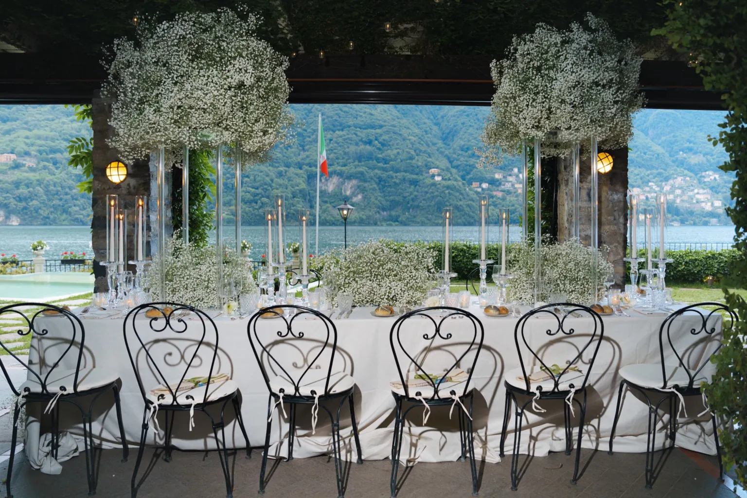 Lake Como, Wedding dinner table with baby's breath and candles overlooking Lake Como