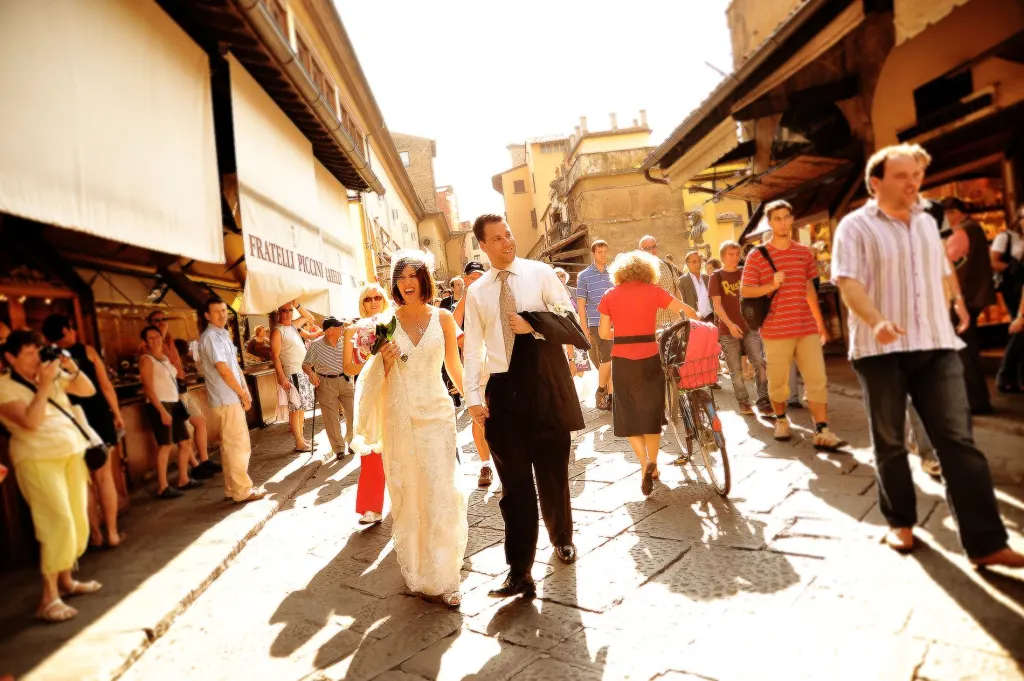 Bride and groom walking near the Ponte Vecchio in Florence