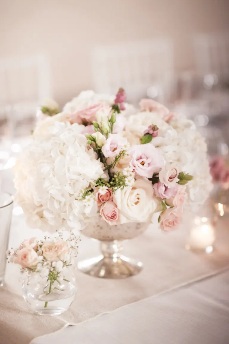 Wedding centrepiece of white hydrangeas and pink roses