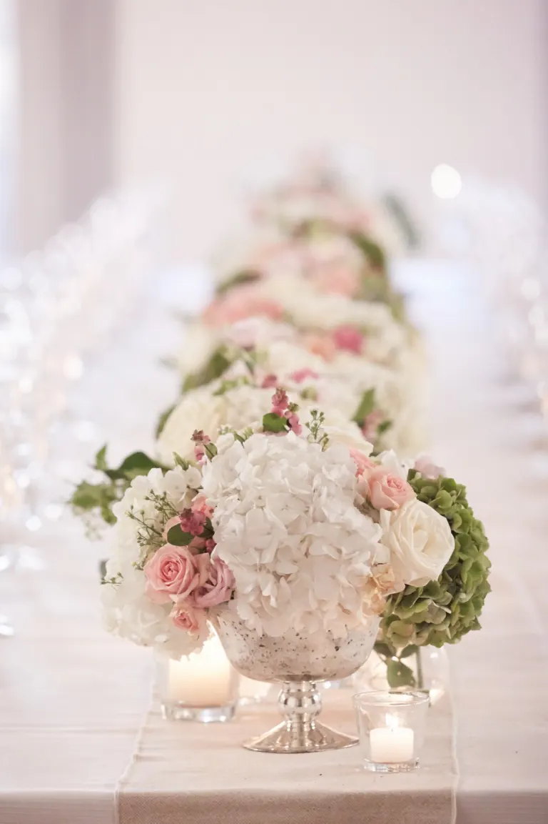 Long wedding table decorated with flowers