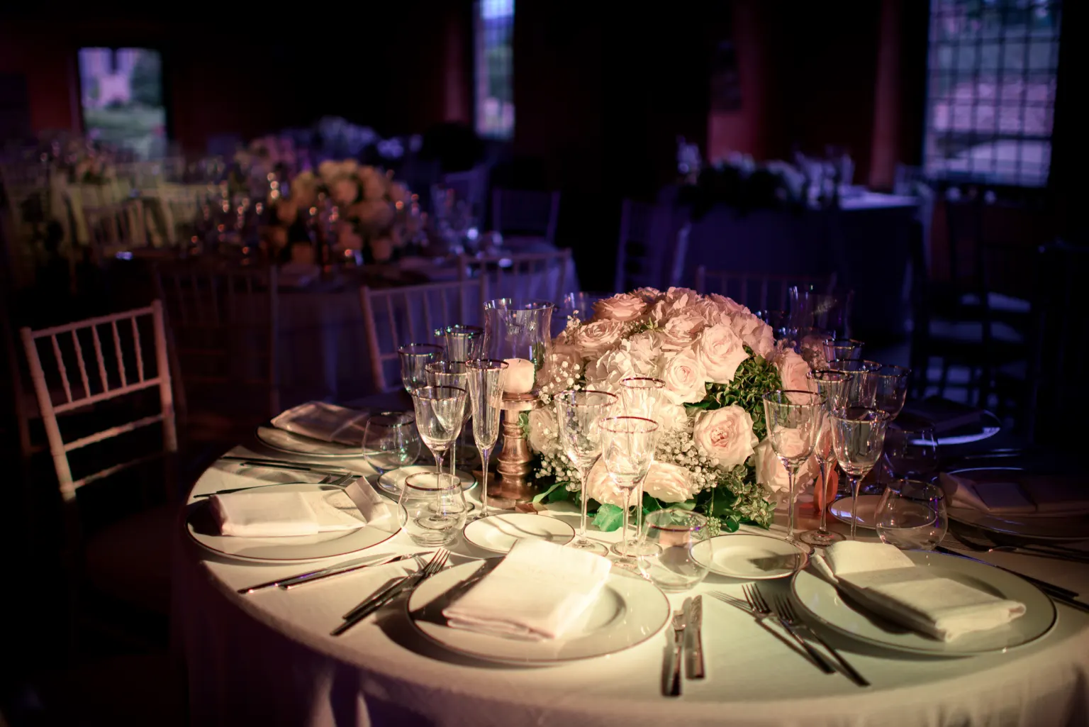 What our fee Round wedding table with pink roses and candlelight
