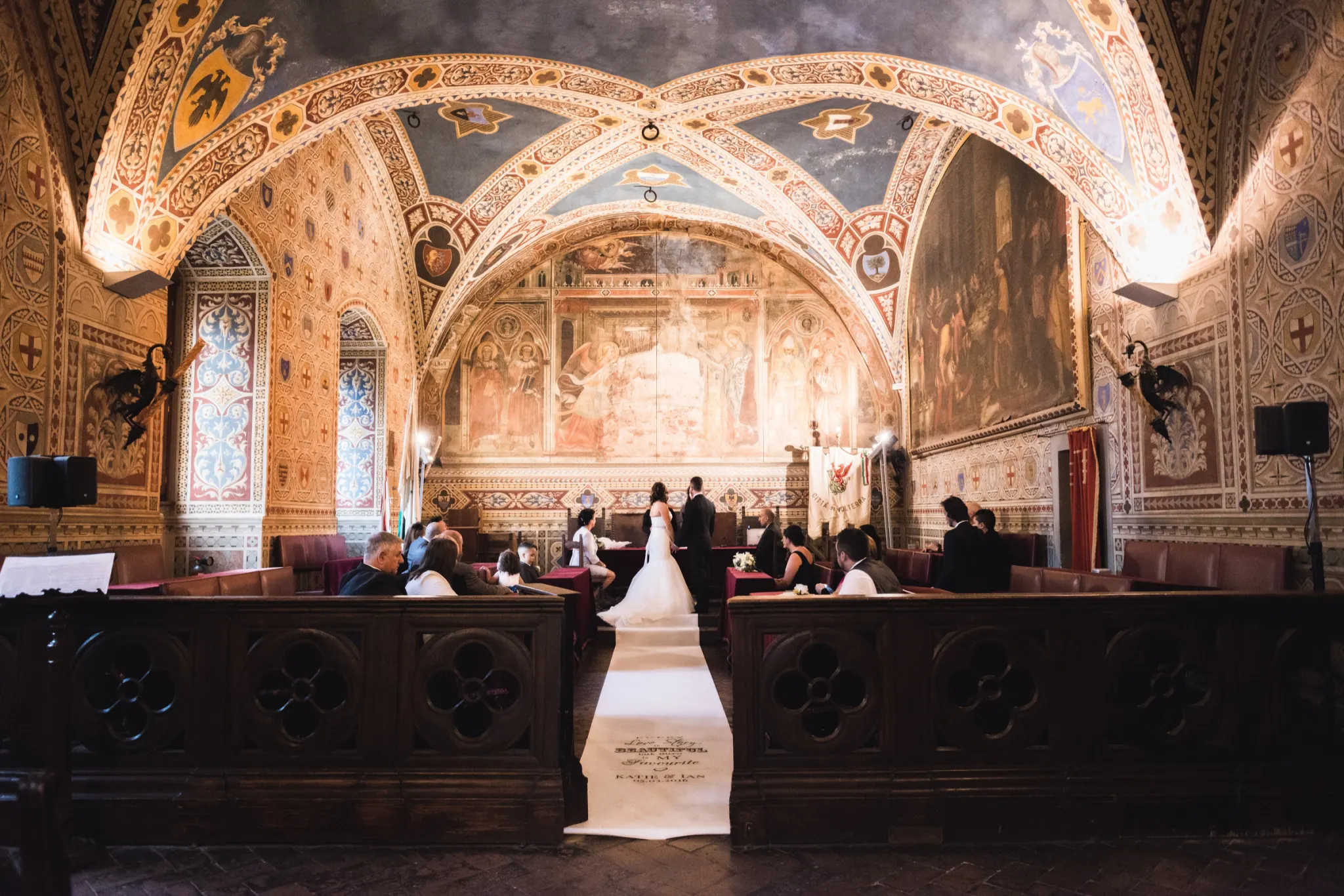 Civil wedding ceremony in the frescoed hall of the Palazzo dei Priori, the town hall of Volterra